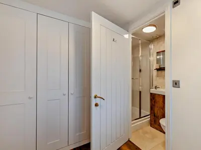 a white bathroom with a shower and a toilet at 2 Bed in Ravenglass oc-95884 in Ravenglass
