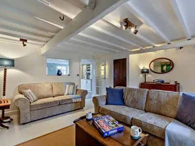 a living room with two couches and a table at 2 Bed in Ravenglass oc-95884 in Ravenglass
