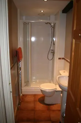 a bathroom with a shower and a toilet and a sink at StoneyAcre in Keswick