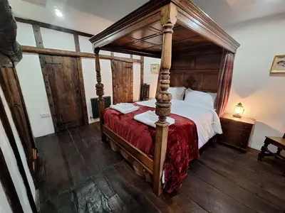 a bedroom with a four poster bed in a room at Field House in Keswick