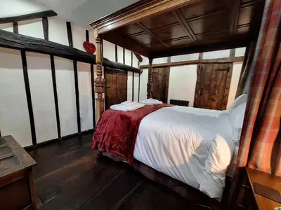 a bedroom with a bed in a room with windows at Field House in Keswick