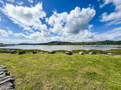a view of a body of water with a grass field at Fleet Townhouse in Gatehouse of Fleet