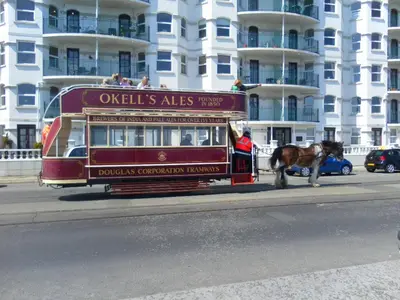 a horse pulling a trolley on a city street at isle of man holiday apartment in Douglas