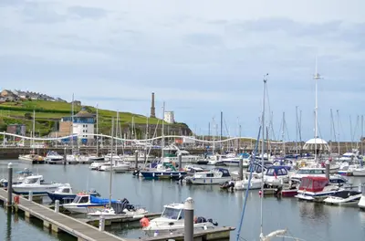 a bunch of boats docked in a harbor at Keekle Cottage - 2 Bedrooms - Sleeps 4 in Cleator Moor