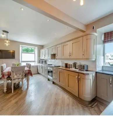 a large kitchen with a table and a dining room at Creebank Cottage with river view in Newton Stewart