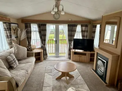 a living room with a couch and a tv at 28 The Beeches in Wigton