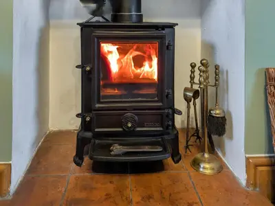a stove is sitting on the floor in a room at Prior Bank in Canonbie