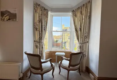 a room with two chairs and a large window at 45 Eskin Street in Keswick