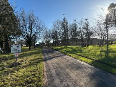 a sign on the side of a dirt road at The Barn in Ellonby