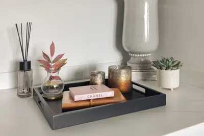 a black shelf with candles and a box on it at The Retreat - Ridgestone in Penruddock