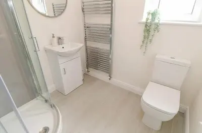a bathroom with a toilet and a sink and a shower at Ploughmans Cottage in Brampton