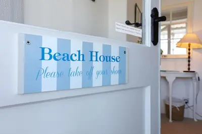a door sign that reads beach house pleasure table of your mind at Allonby Cottage in Kippford