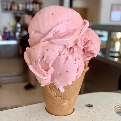 a pink ice cream cone sitting on a table at Lilac Cottage - Fell views & walks from the door in Cleator Moor
