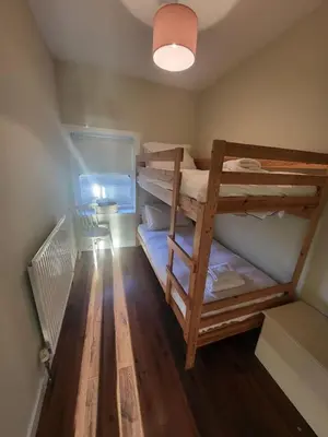 a room with two bunk beds in a room at The Wee House -Coorie Doon Stays in Troon