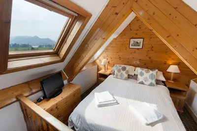 a bedroom with a bed and a tv in a cabin at Berkeley House in Keswick