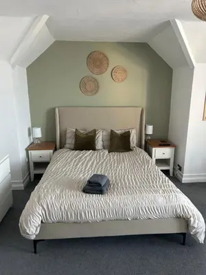a bedroom with a large bed with two night stands at Lakenhow in Seascale