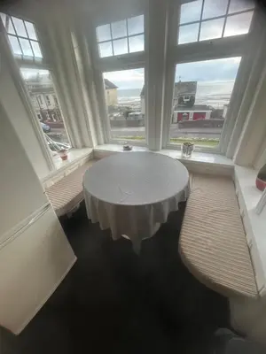 a white table in a room with two windows at Lakenhow in Seascale