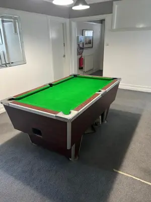 a pool table in a room with a green cloth at Lakenhow in Seascale