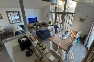 a living room with a blue couch and a table at Fig Tree Lodge in Ellonby