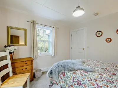 a bedroom with a bed and a window and a table at 1 Bed in Maybole 93562 in Maybole