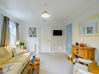 a living room with a couch and a table at 1 Bed in Maybole 93562 in Maybole