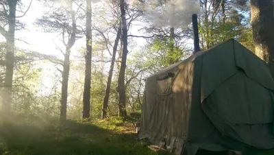 a tent in the middle of a forest at The Hidden Mill, Historic Beauty Spot and spa in Castle Douglas