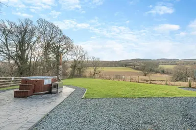 a garden with a hot tub and a grass field at 3 Bed in Isel oc-i30816 in Sunderland