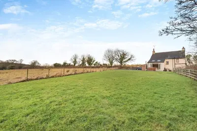 a large grassy field in front of a house at 3 Bed in Isel oc-i30816 in Sunderland