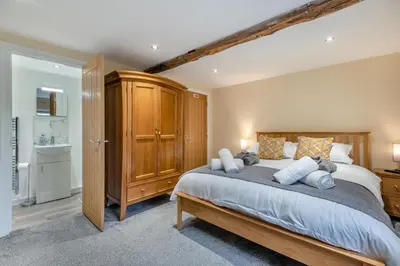 a bedroom with a large bed and a bathroom at 3 Bed in Isel oc-i30816 in Sunderland