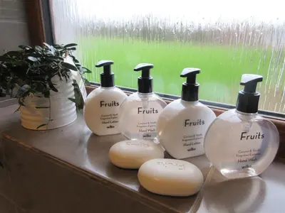 a group of four bottles of soap on a window sill at Allanhead Cottage in Kirkcudbright