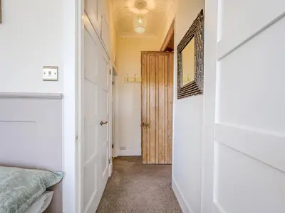 a hallway with a door leading to a bedroom at Piersland Mews in Troon