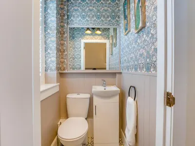 a small bathroom with a toilet and a sink at Piersland Mews in Troon