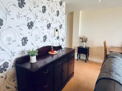 a bedroom with a dresser in front of a wall at Pears Suite - 1 Bedroom - Sleeps 2 in Whitehaven
