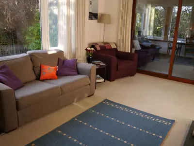 a living room with a couch and a rug at Calluna Cottage in Rockcliffe