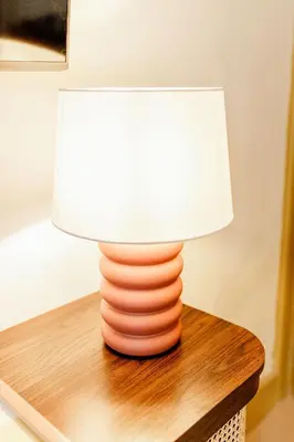 a lamp sitting on top of a wooden table at Bedroom 2 - Rockcliffe in Dumfries