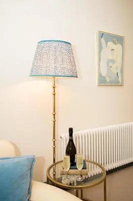 a table with a bottle of wine and a lamp at Torr House Hotel in Dumfries