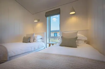 a bedroom with two beds and a window at Crabtree Lodge in Girthon
