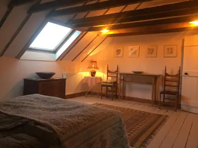 a bedroom with a bed and a desk and a window at Holly Lodge, Gilchristland Organic Farm cottage in Closeburn