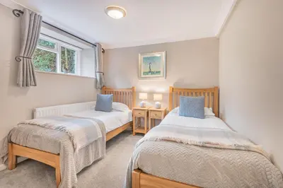 a bedroom with two beds and a window at Cozy Lake District House on the fells in Ambleside