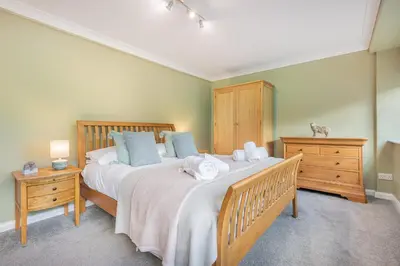 a bedroom with a large bed with two night stands at Cozy Lake District House on the fells in Ambleside