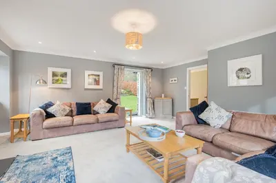 a living room with two couches and a table at Cozy Lake District House on the fells in Ambleside