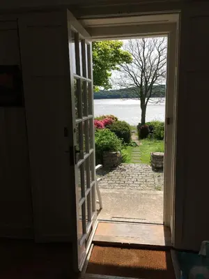 an open door with a view of a yard at Elm Cottage in Kippford