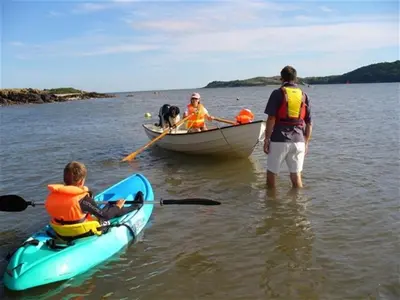a group of people and a dog in a boat at Elm Cottage in Kippford