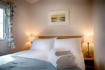 a bedroom with a bed with towels on it at Konkers in Girthon