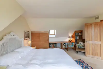 a bedroom with a large white bed in a room at Lochpatrick Mill in Castle Douglas