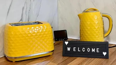 two yellow vases sitting on the floor with a welcome sign at No23 - Bright & spacious 2nd floor flat - PET friendly - Noon check out in Stanwix