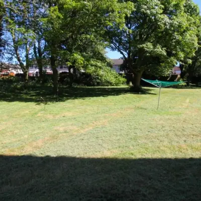 a park with trees and a hammock in the grass at No23 - Bright & spacious 2nd floor flat - PET friendly - Noon check out in Stanwix