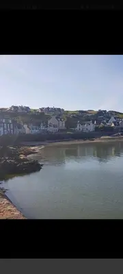a large body of water with houses in the background at Portpatrick 2 bedroom Self Catering Flat in Portpatrick