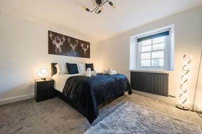 a bedroom with a bed and a window at Modern Town House In Cockermouth in Cockermouth