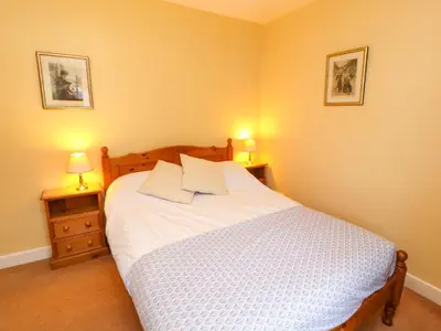 a bedroom with a white bed with two night stands at Maiden Moor in Keswick